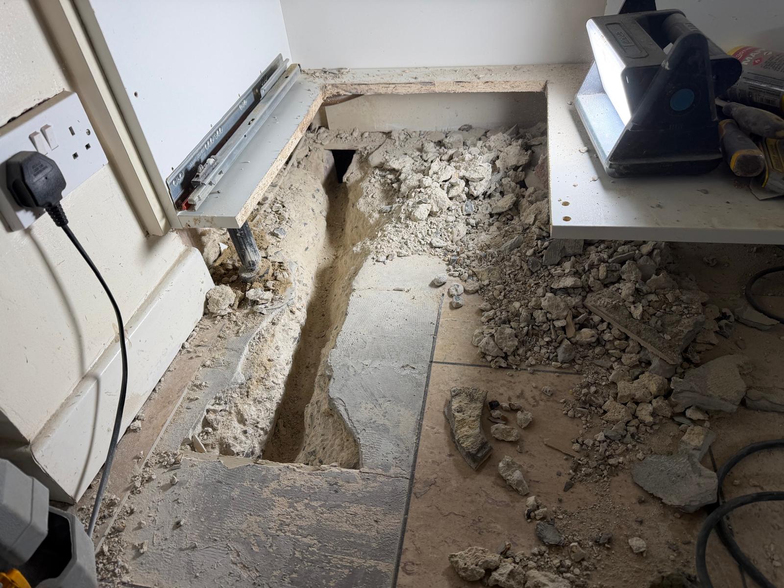Floorboards removed to trace concealed pipework